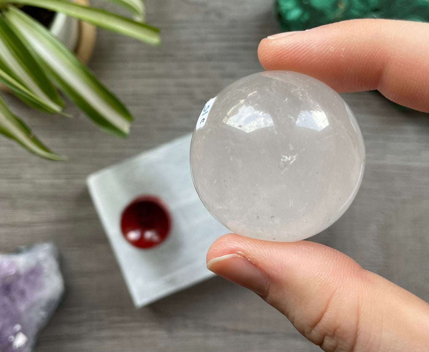 Pictured is a sphere carved out of clear quartz. Clear Quartz Mini Crystal Sphere 38mm (B) back