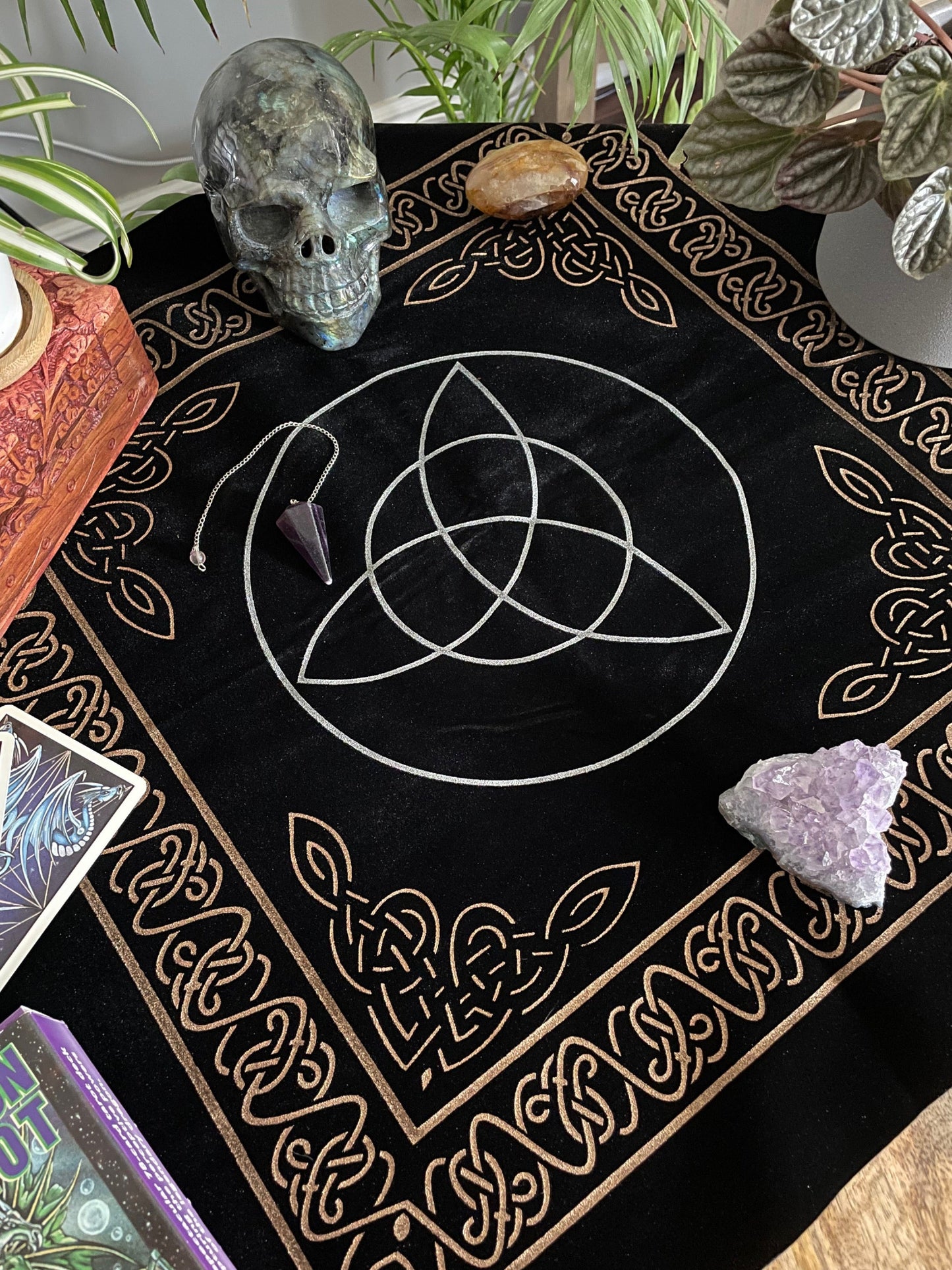 Pictured is a black velvet altar cloth with a silver triquetra in the middle. Triquetra Altar Cloth