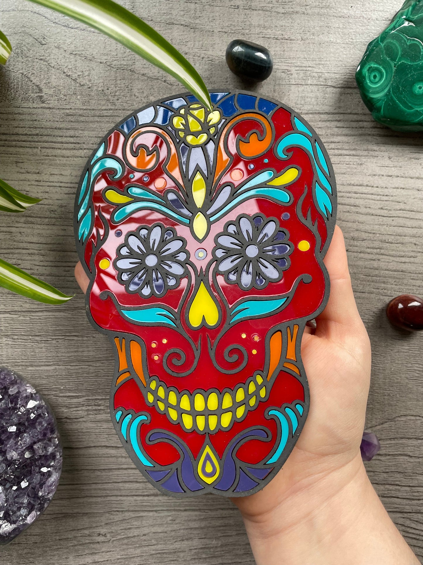 Pictured is a faux stained glass sugar skull made out of wood and acrylic. Sugar Skull Wall Art (Red) close up