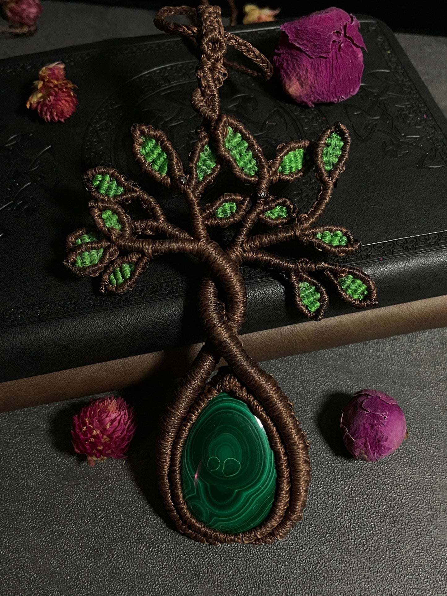 A handmade macrame necklace featuring a tree design with a malachite cabochon as its centerpiece. Malachite Tree of Life Macramé Necklace (Twisted Nightshade Jewellery) - The Wandering Fox Emporium, Your Crystal Store